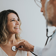 a photo of a doctor using a stethoscope on a patient